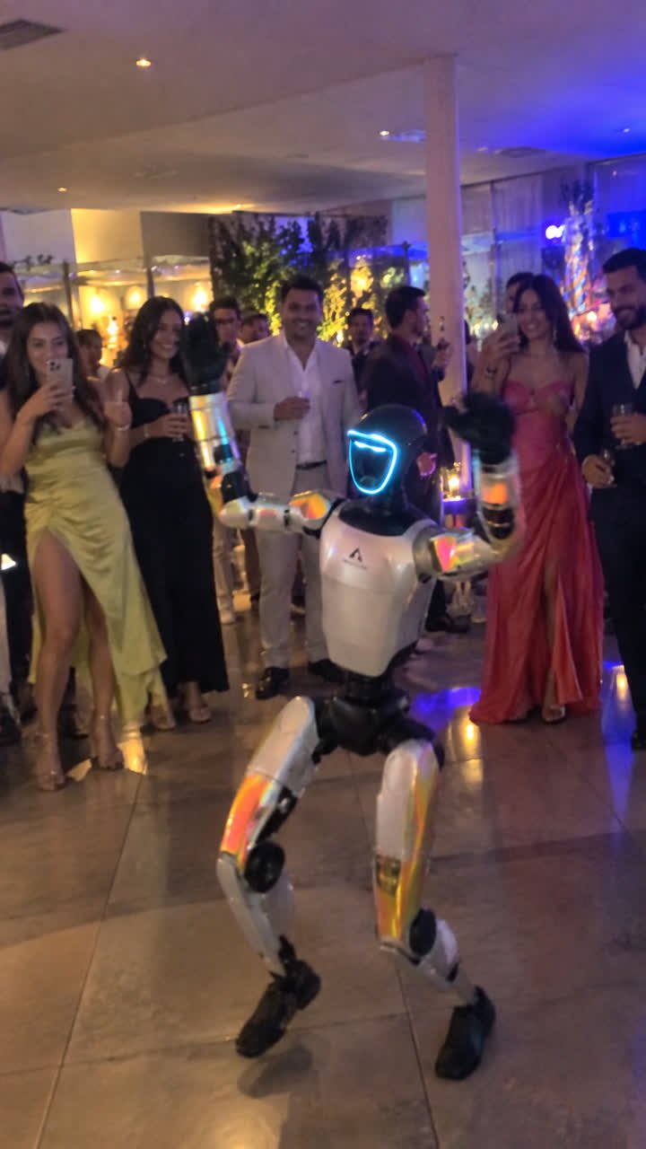 Humanoid robot dancing among party guests