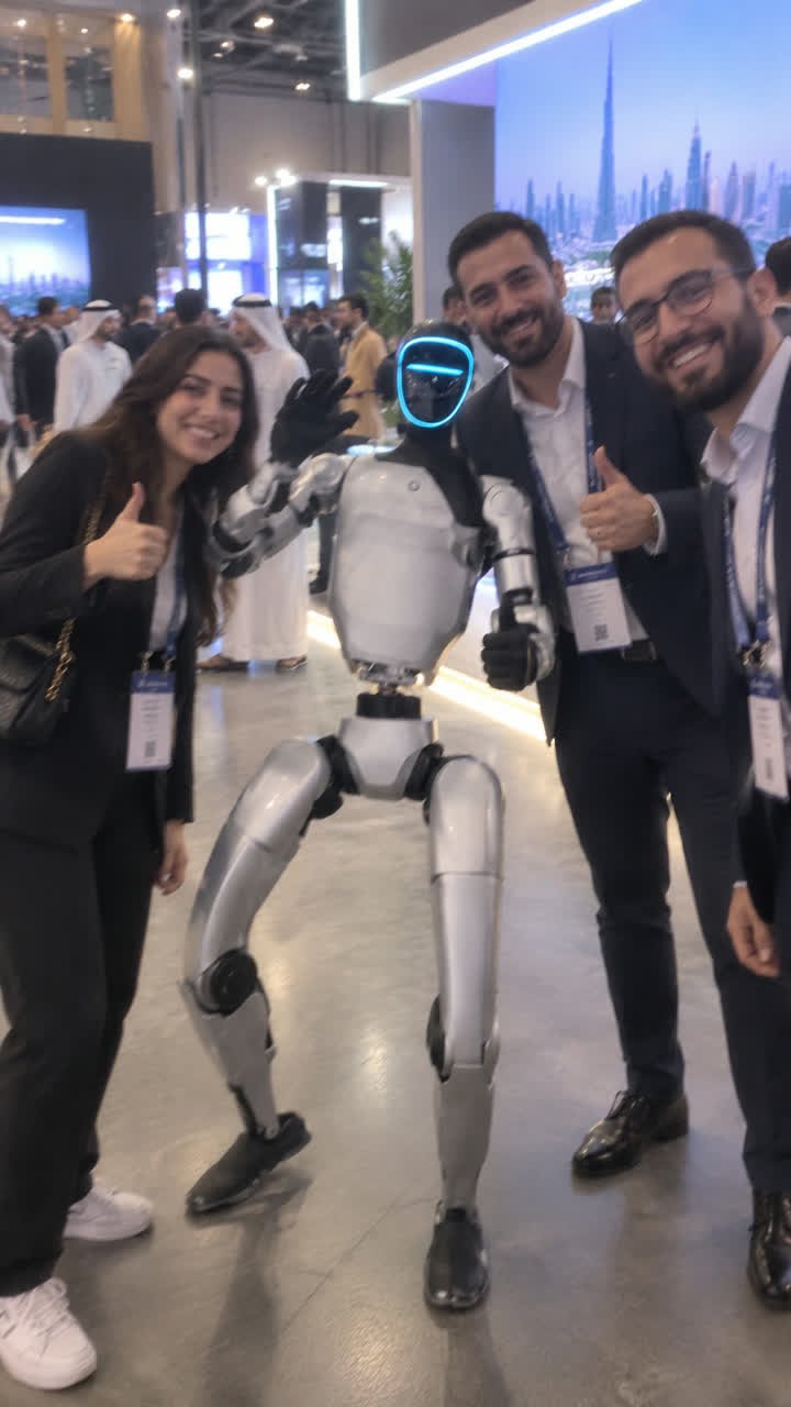 Event visitors posing beside a robot